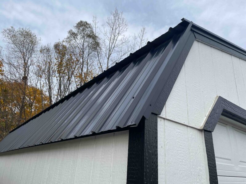 shed with garage door and metal rtoof